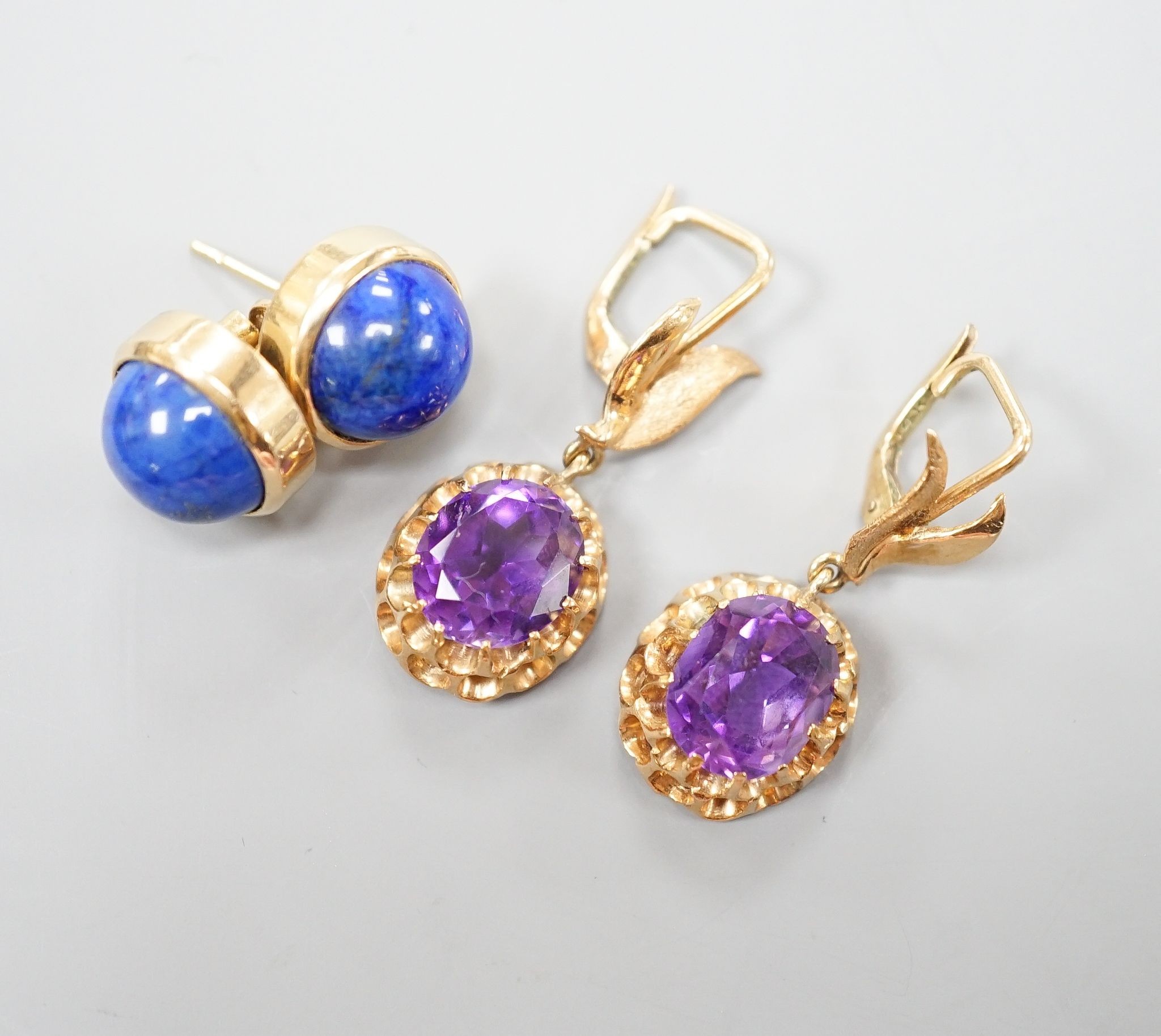 A modern pair of 14k yellow metal and amethyst set drop earrings, 29mm and a similar pair of lapis lazuli set earrings, gross weight 13.9 grams.